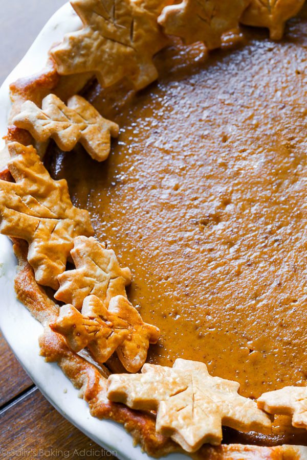 unsliced pumpkin pie with pie crust designs